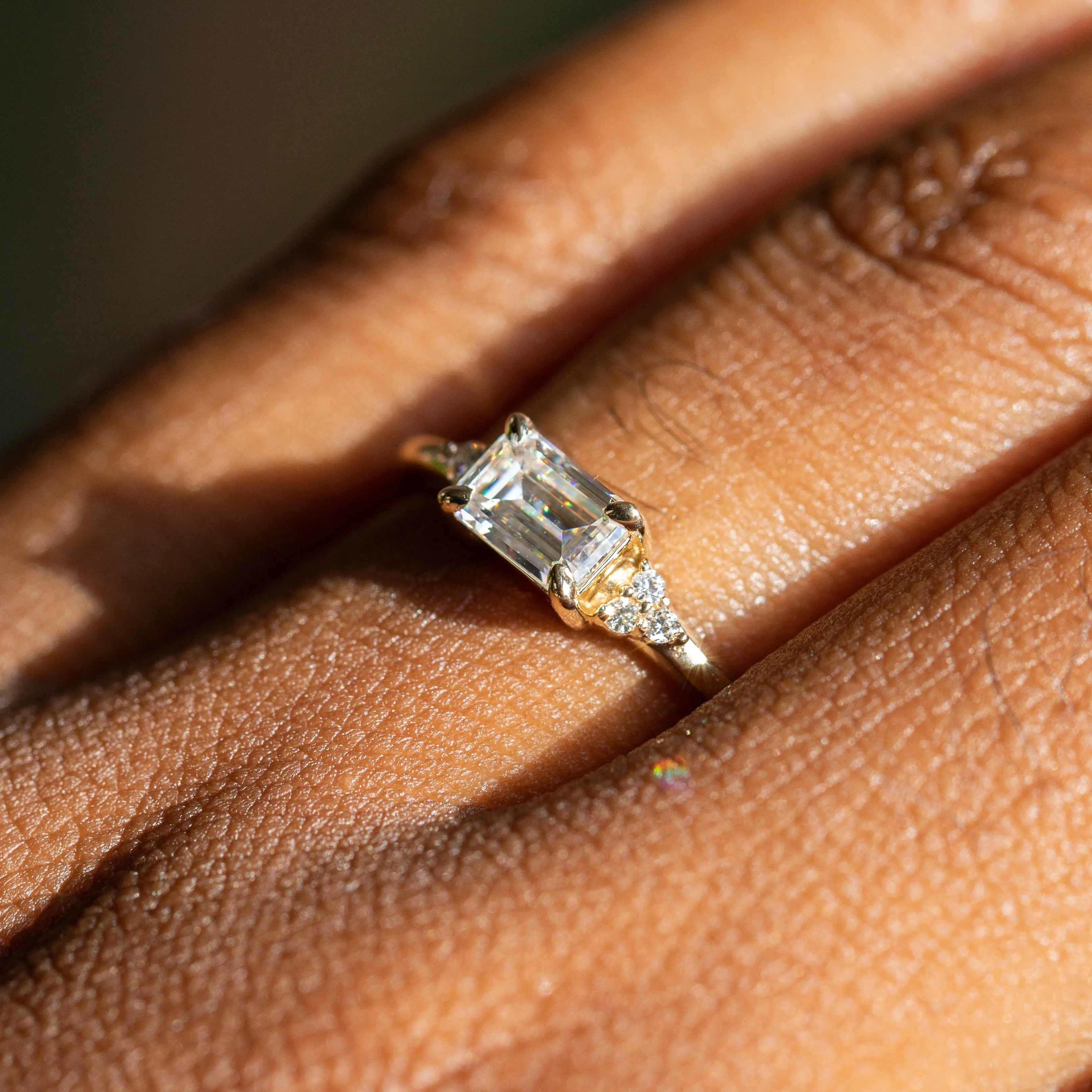 East-West Emerald cut Moissanite Asymmetrical Ring in 14k Yellow Gold