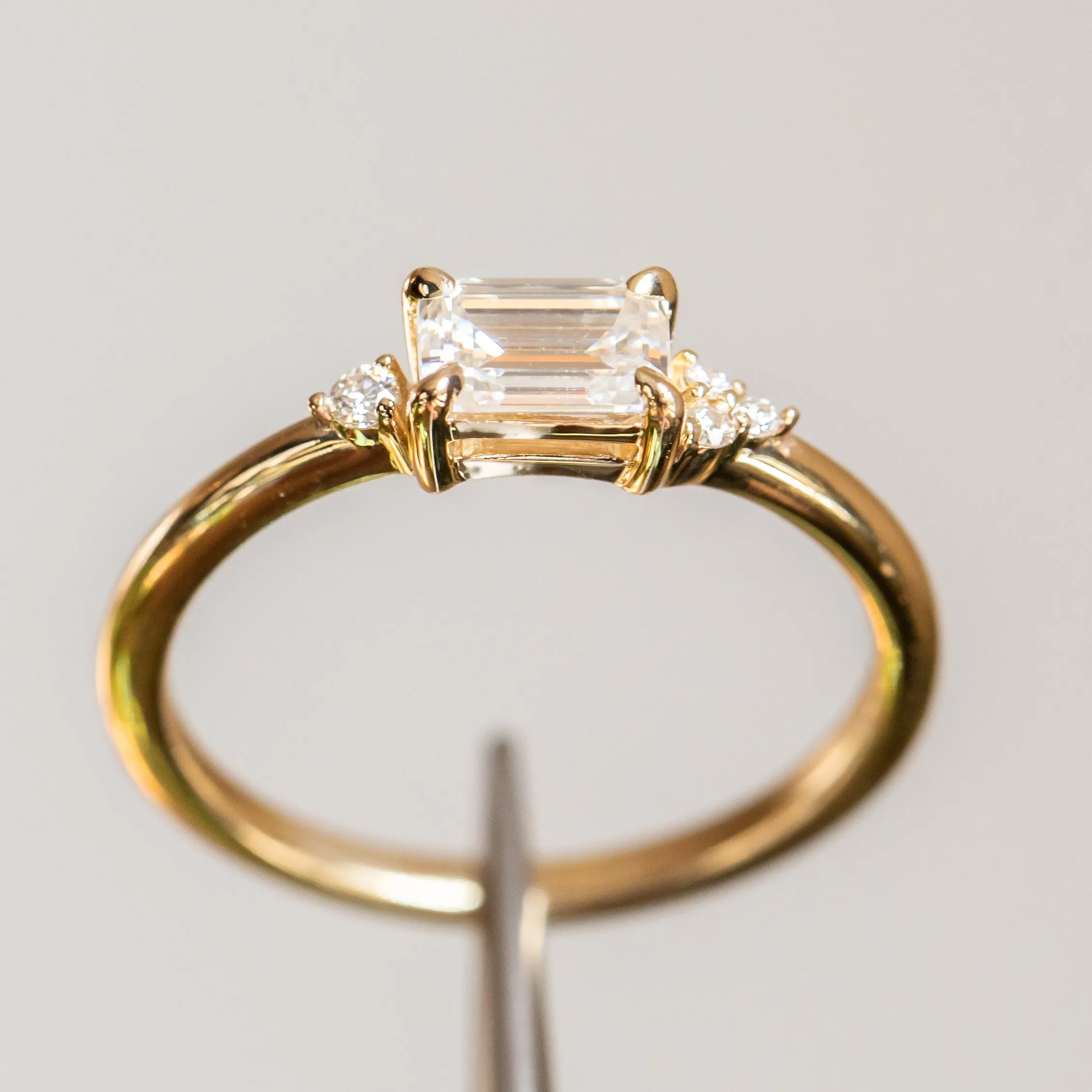 East-West Emerald cut Moissanite Asymmetrical Ring in 14k Yellow Gold