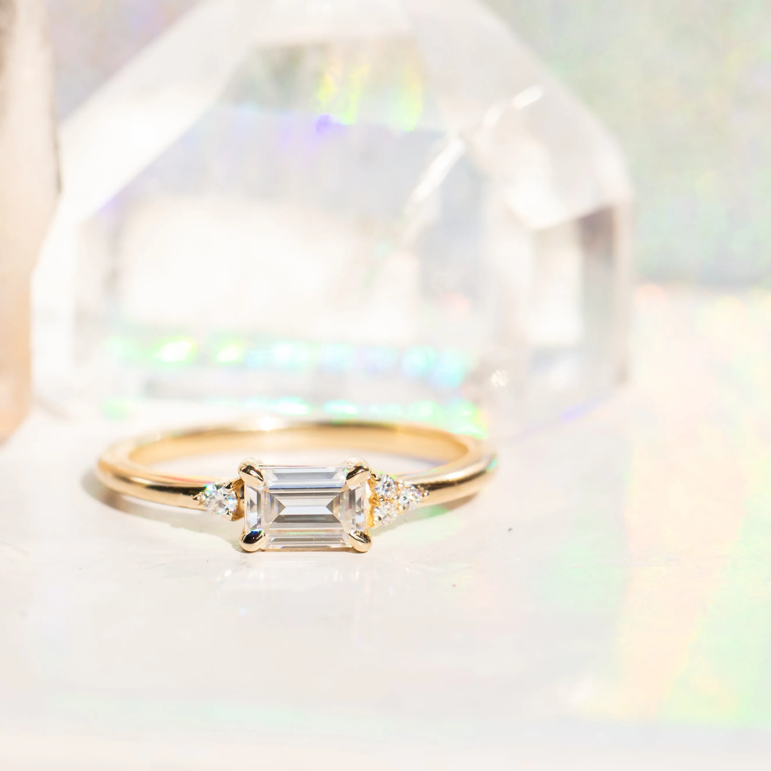 East-West Emerald cut Moissanite Asymmetrical Ring in 14k Yellow Gold