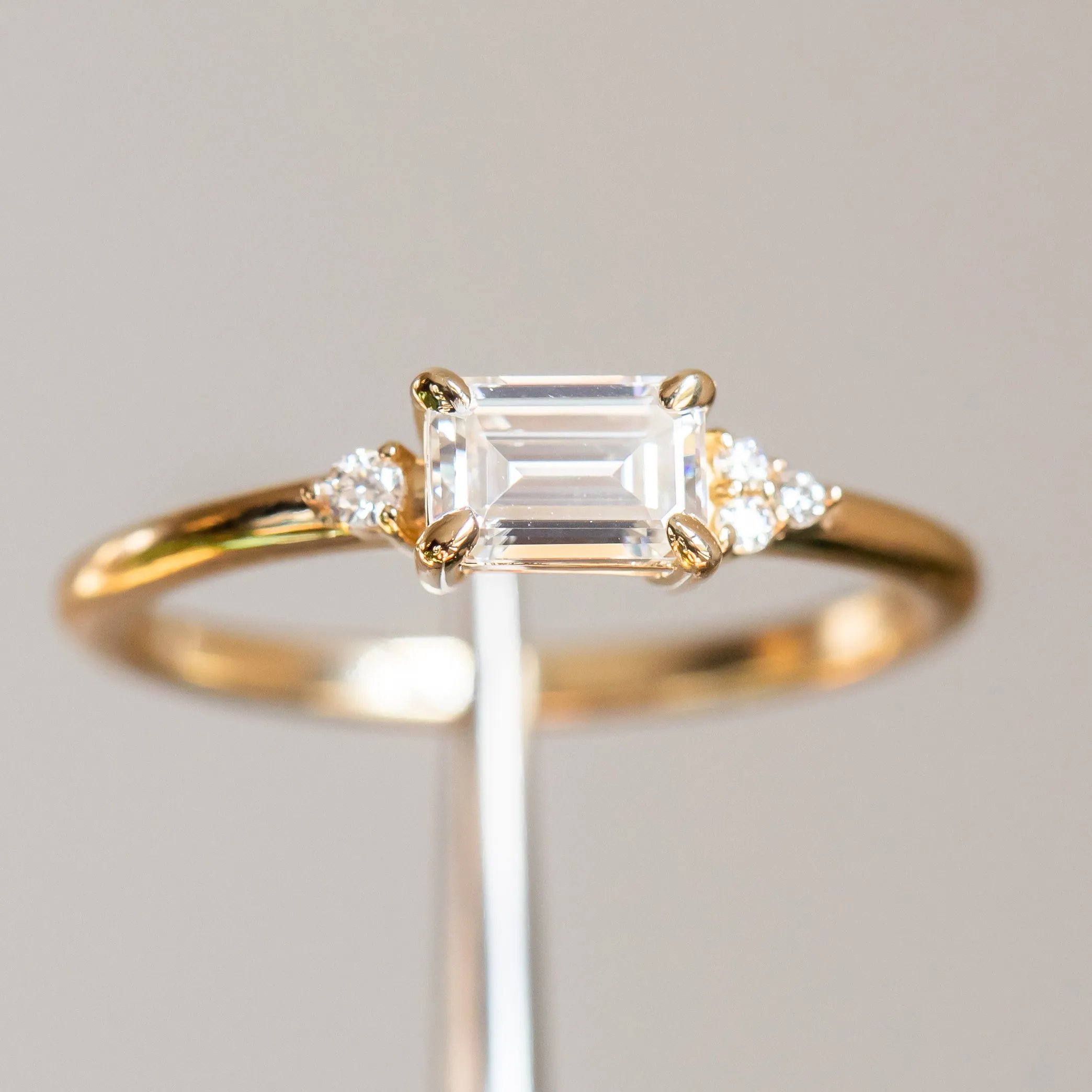 East-West Emerald cut Moissanite Asymmetrical Ring in 14k Yellow Gold